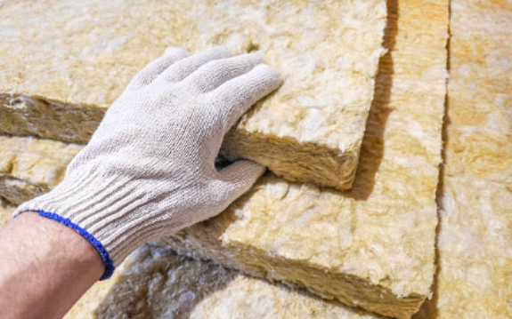Glass wool insulation material being handled